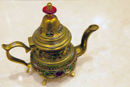 gold teapot sharp marble backgroundの写真素材
