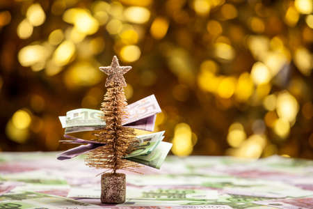 fir tree money table gold bokehの写真素材