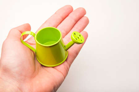 watering can hand white backgroundの写真素材