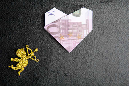 cupid money dark leather backgroundの写真素材