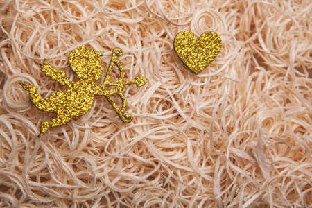 gold cupid heart wooden backgroundの写真素材
