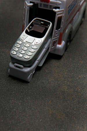 mobile phone toy car asphalt backgroundの写真素材