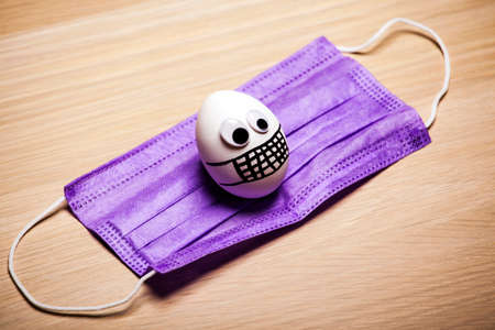 image of chicken egg and mask on tableの写真素材