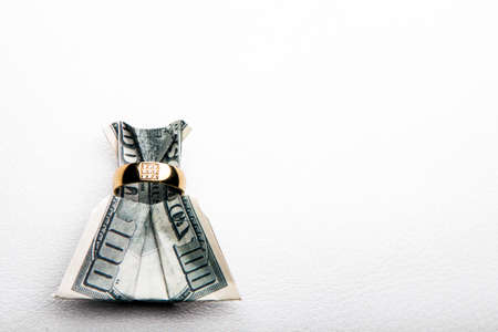 image of money with ring on white backgroundの写真素材