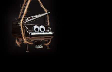 image of black piano rope dark background