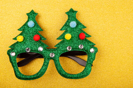 Glitter Christmas tree specks on yellow glittersの写真素材