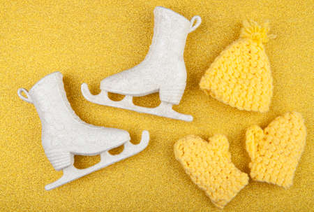 A pair skates and wool glove on yellow glitterの写真素材