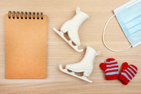 image of skates notepad mask glove wooden desk background