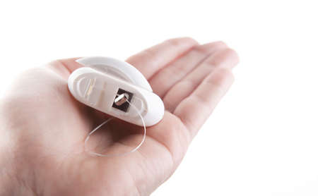 image of dental floss hand white background