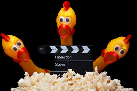 image of pop corn clapper board rubber chicken dark backgroundの写真素材