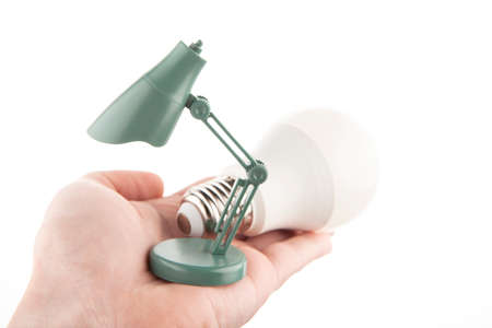 image of miniature lamp bulb hand white backgroundの写真素材