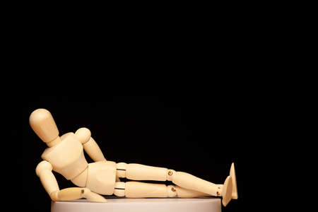 image of wooden figure dark backgroundの写真素材