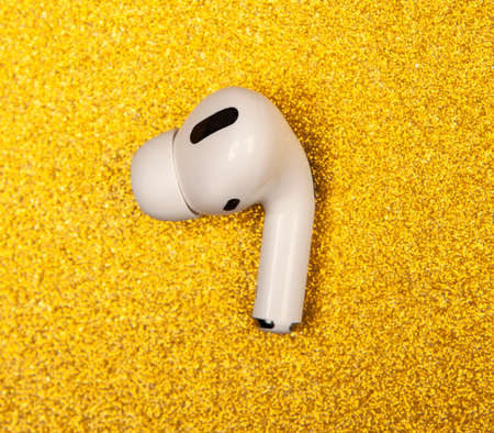 image of earphones gold background
