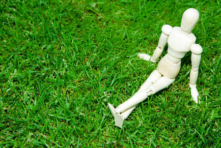 image of wooden mannequin grass backgroundの写真素材