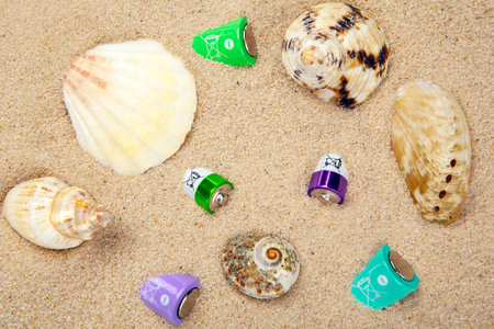 battery seashell sand background