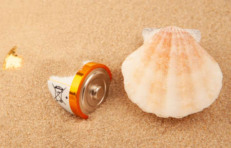 battery seashell sand background