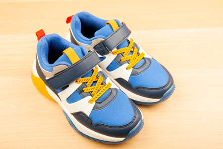 image of sneakers wooden desk backgroundの写真素材