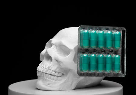 skull pills dark background