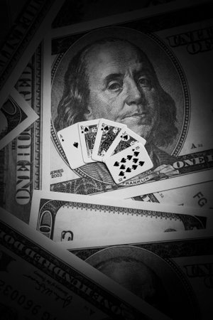 Dollar banknotes and playing cards. Black and white photo.