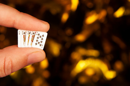 Playing cards in hand on bokeh background