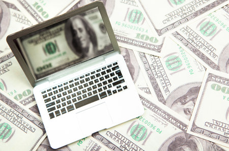 miniature computer money banknote backgroundの写真素材
