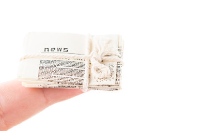 small newspaper with rope on white backgroundの写真素材
