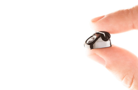 Close up of a hand holding a telephone receiver on a white backgroundの写真素材