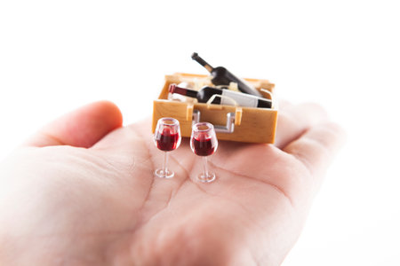 Two glasses of red wine in a wooden box on a white backgroundの写真素材