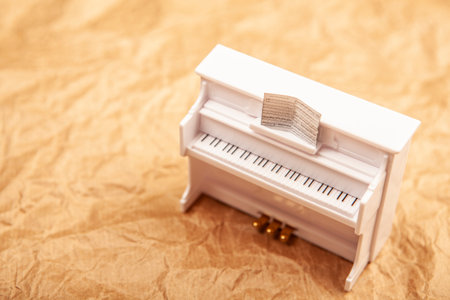 White piano on a crumpled paper background. Selective focus.の写真素材