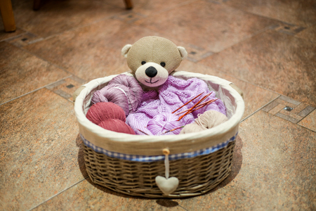 A teddybear-like basket full of different colored yarn.の写真素材