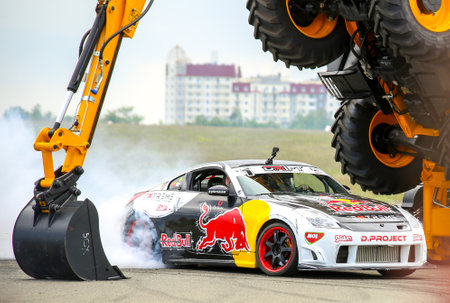 KIEV, UKRAINE - MAY 20: Ukrainian Drift Champion Alex Grinchuk drive the Nissan 350Z under agricultural machine JCB , May 20, 2017, Aviafest at Chayka airfield in Kiev, Ukraineのeditorial素材
