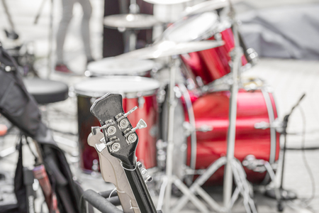Two electric guitars a drums kit on a background in outdoor location.の写真素材