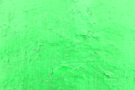 Cracked toxic green paint texture. Close-up of old painted red wall. Abstract grunge background. Vintage scratched surface.の写真素材