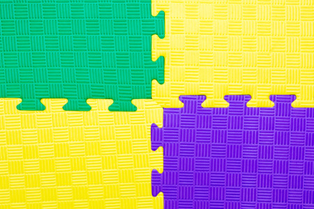 Close-up of baby playing mat background.  Jigsaw soft rubber surface texture. Foam floor children mat connection.の写真素材