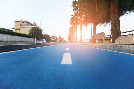 Separate blue bike lane near beach at ocean resort. Cycling path for sport and healthy lifestyle....