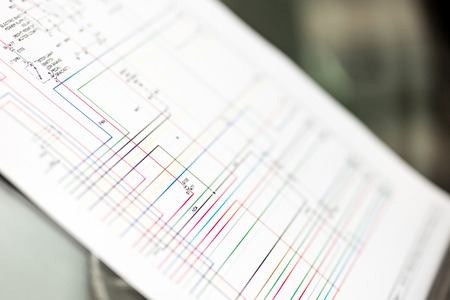 Colorful cars electric wiring scheme on paper sheetの写真素材