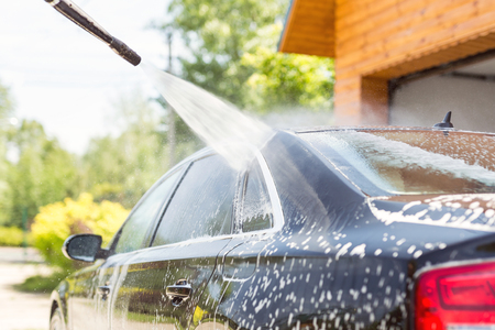 Manual car wash. Washing luxury vehicle with high pressure water pump.Automobile  cleaning self serviceの写真素材