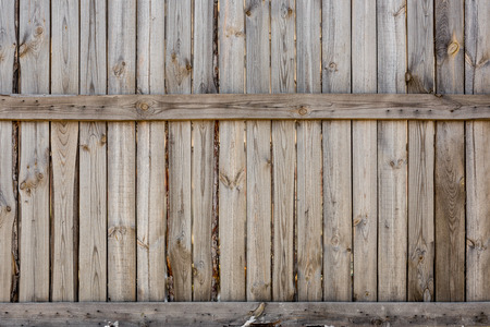 Close-up of vertical simple oak wooden fence background.  Old knotted timber wall. Vintage rustic pattern. Copyspaceの写真素材