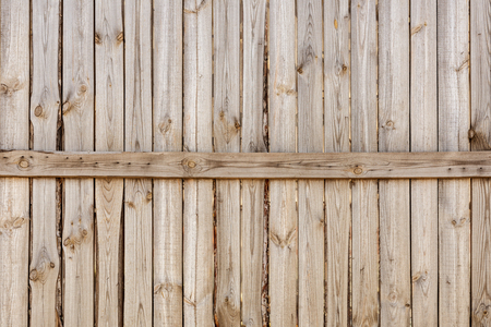 Close-up of vertical simple oak wooden fence background.  Old knotted timber wall. Vintage rustic pattern. Copyspaceの写真素材