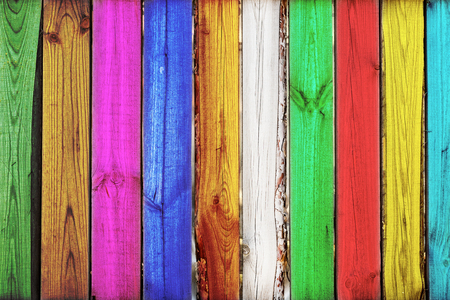 Close-up of bright vertical colorful oak wooden fence background. Creative art backdrop.Vintage rustic multicolored pattern. Copyspace.の写真素材
