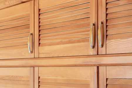 Modern wooden cabinet in classic rustic style. Details of wardrobe case with shutter plank doors. Country house interiorの写真素材