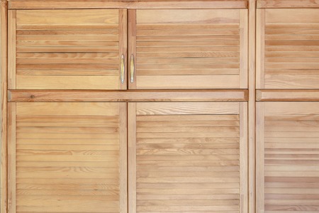 Modern wooden cabinet in classic rustic style. Details of wardrobe case with shutter plank doors. Country house interiorの写真素材