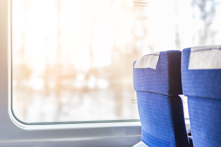 Interior of modern intercity express train. Back view of wide comfortable seats in row at railroad transportの写真素材