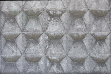 Concrete fence with geometric relief. Grey abstract grunge aged backgroundの写真素材