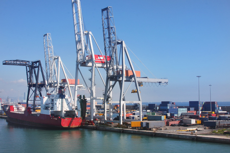 Container ship moored at idustrial cargo port. Export and import water shipping and logistics. Global tradenig.の写真素材