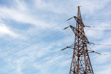 High-voltage electricity pylon with blue clear sky on background. Energy transmission.の写真素材