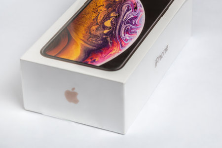 12th October,2018-Kiev,Ukraine: Latest Iphone XS in unopened box on white table. Newest Apple smartphone on white branded box in mobile store. Modern gadget with dual camera and OLED screen for saleのeditorial素材