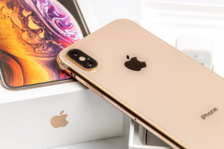 12th October,2018-Kiev,Ukraine: Latest Iphone XS on opened box on white table. Newest Apple smartphone on white branded box in mobile store. Modern gadget with dual camera and OLED screen for saleのeditorial素材