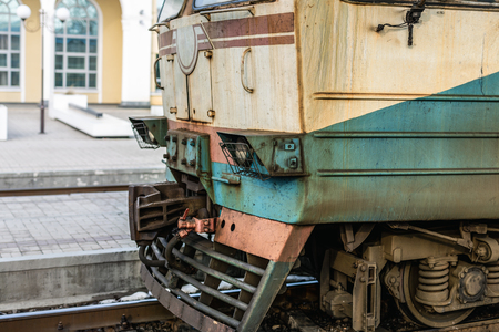 close-up Old rusty diesel train locomotive at railway station. Outdated technology cargo transport vehicle.の写真素材