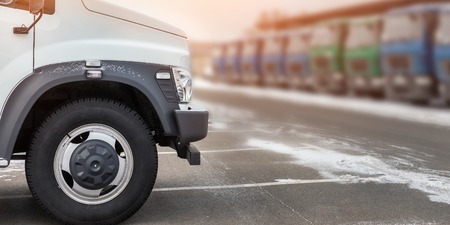 New middle size trucks at dealership parking outdoors at winter. Truck service and maintenance....